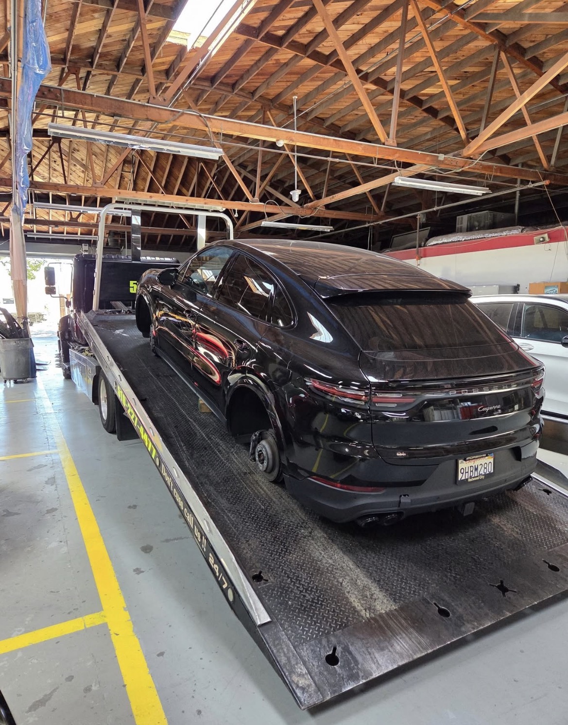 Black Porsche Cayenne loaded on Rivera's Towing flatbed