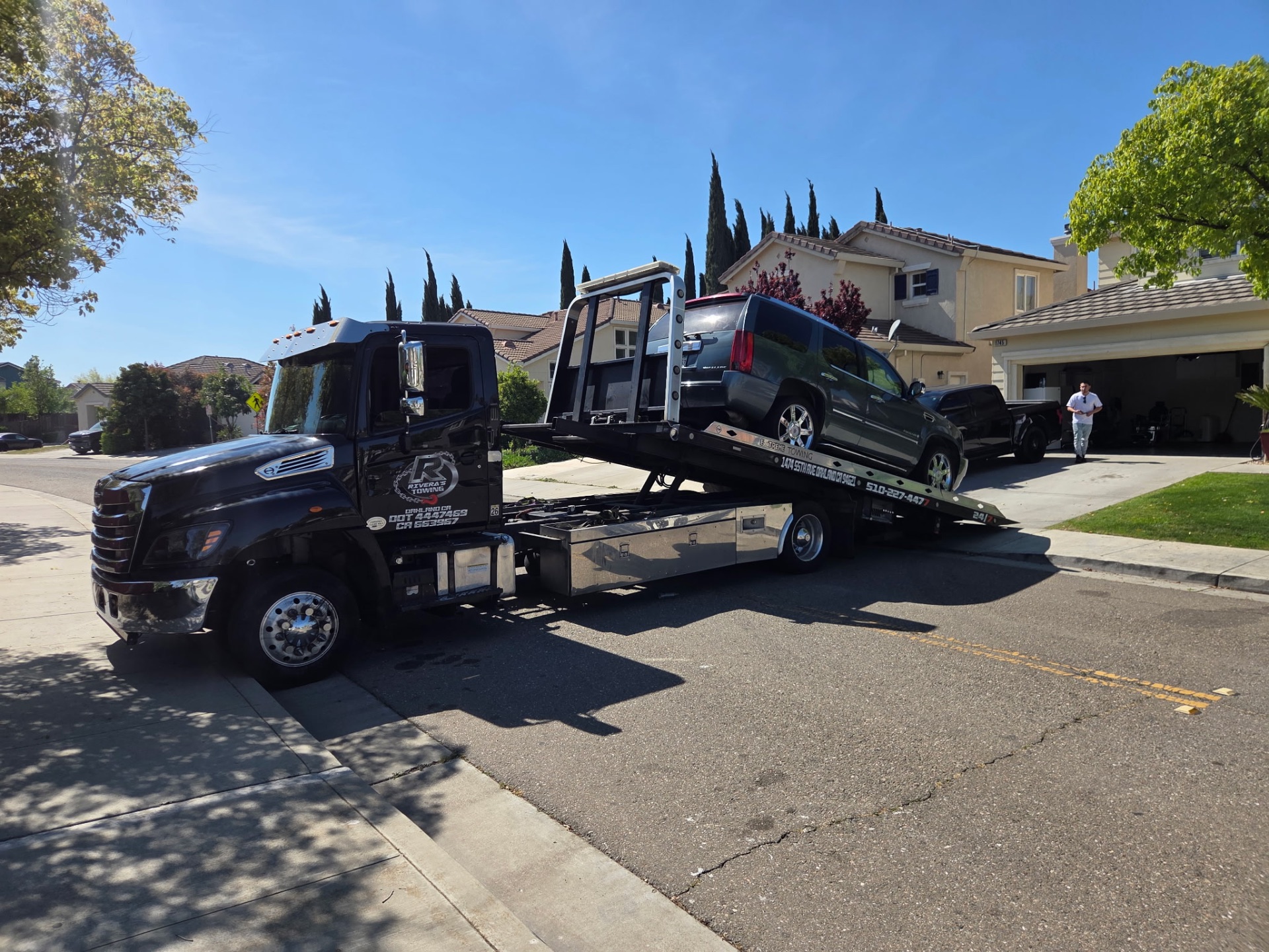 Cadillac Escalade loaded on Rivera's flatbed for residential pickup