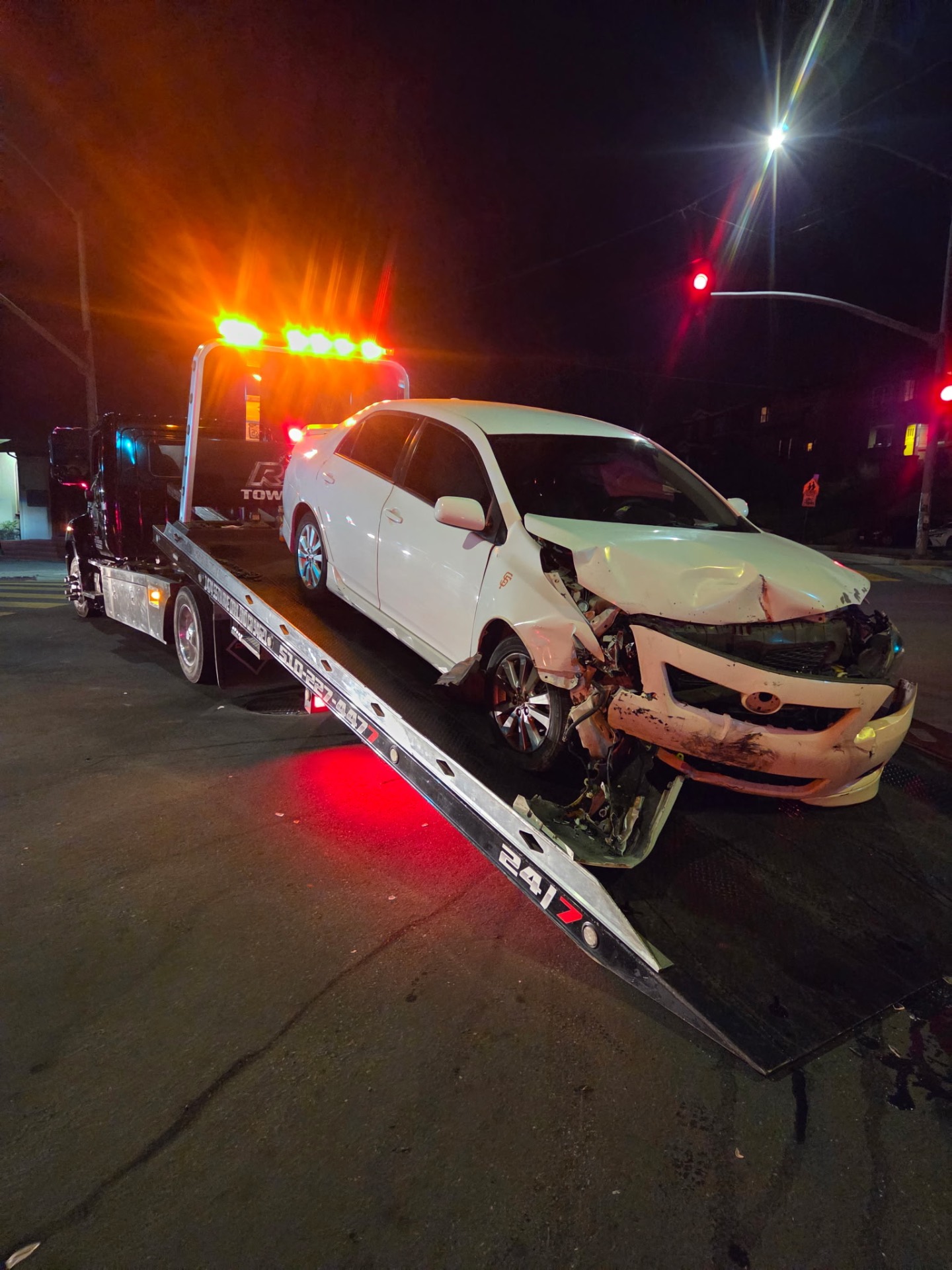 Rivera's Towing night accident recovery of a wrecked Toyota Corolla in Oakland